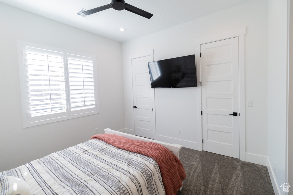 Carpeted bedroom with ceiling fan