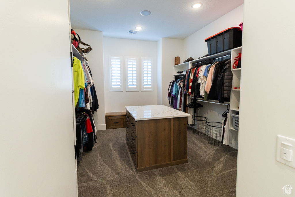 Walk in closet with dark carpet