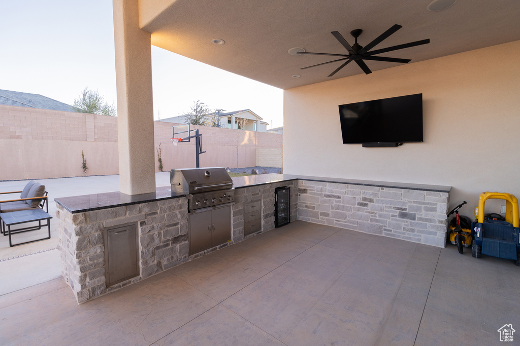 View of patio featuring exterior kitchen, area for grilling, and ceiling fan