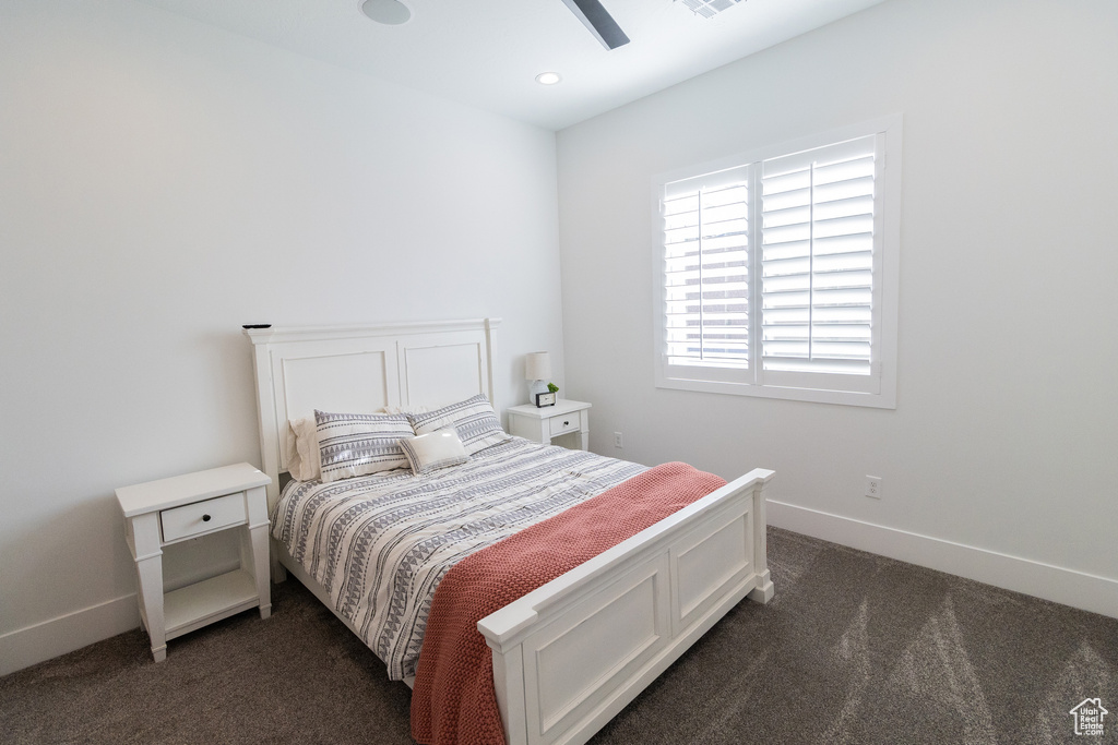Carpeted bedroom with ceiling fan