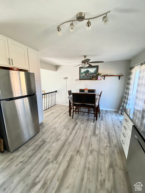 Dining room with ceiling fan and light hardwood / wood-style flooring