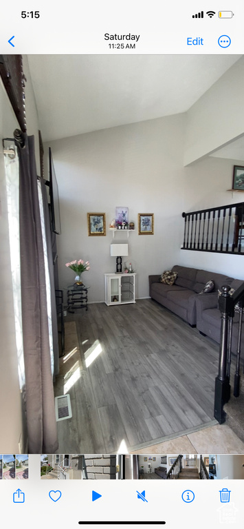 Living area featuring wood finished floors and vaulted ceiling