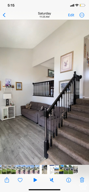 Stairway featuring wood finished floors