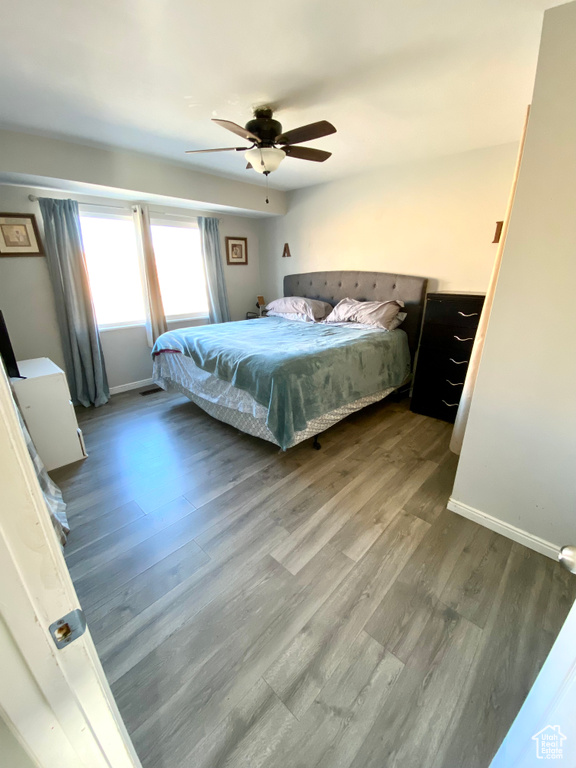 Bedroom with hardwood / wood-style flooring and ceiling fan