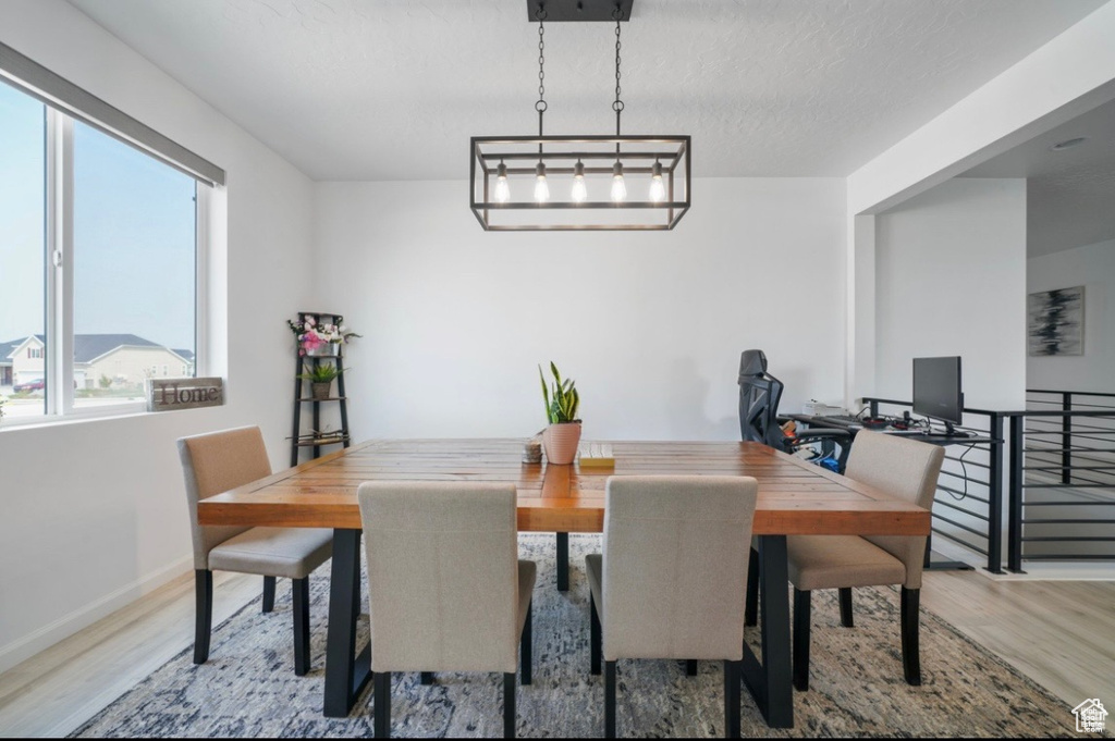 Dining space featuring baseboards and wood finished floors