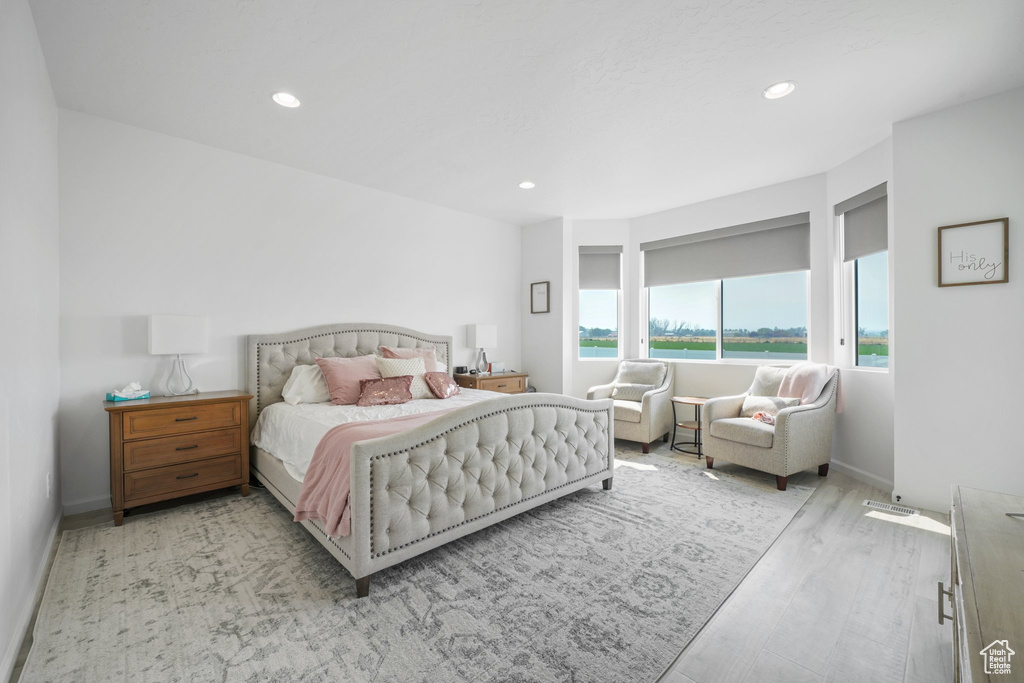 Bedroom with light hardwood / wood-style floors