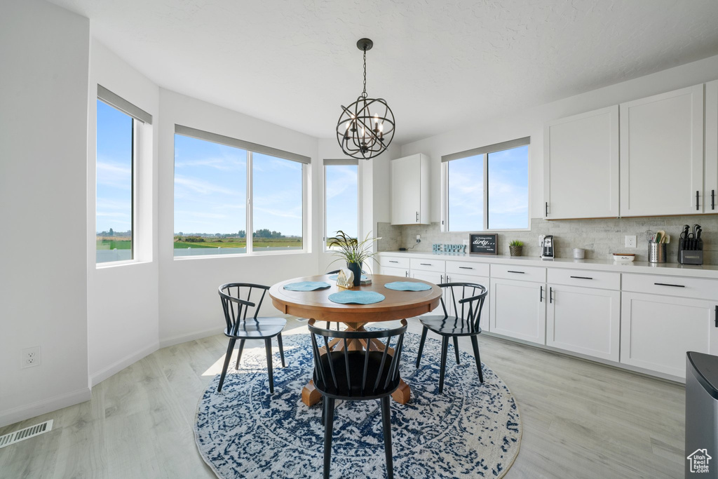 Dining room featuring a chandelier and light hardwood / wood-style floors