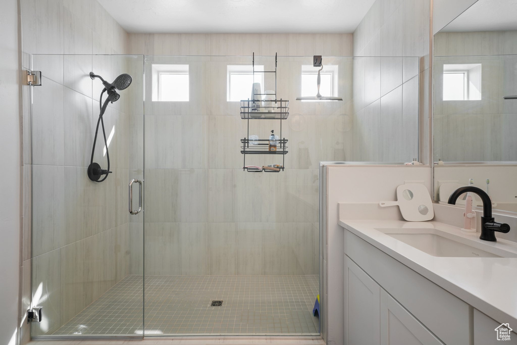 Bathroom with vanity and a shower with shower door