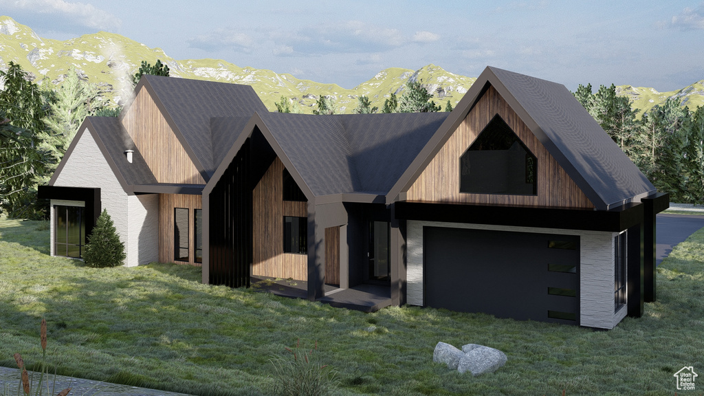 View of front of house with a mountain view, a garage, and a front lawn