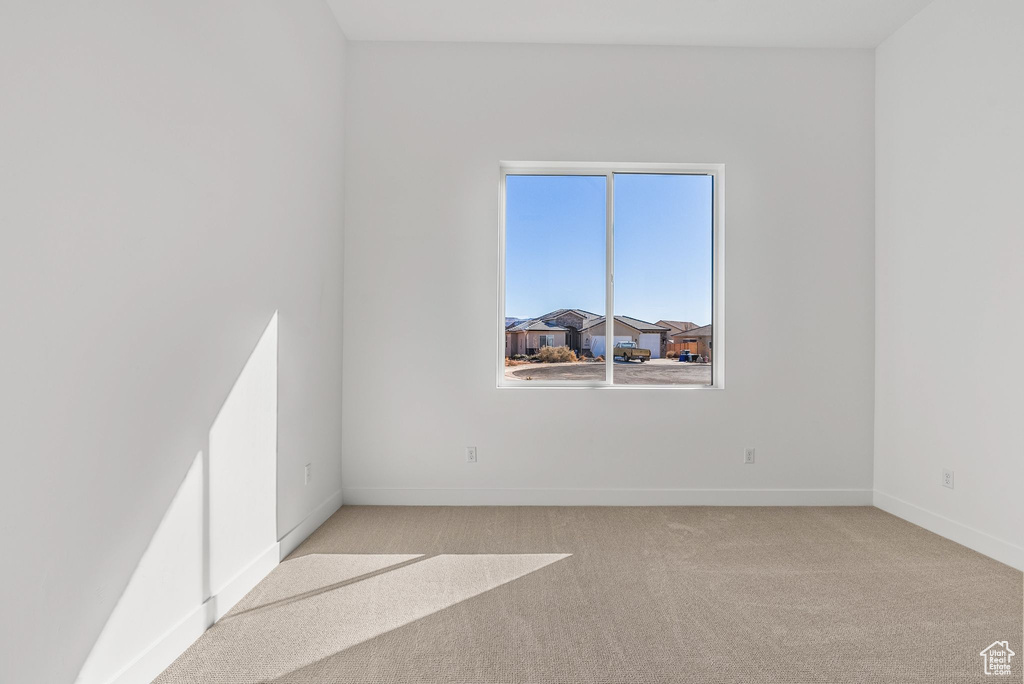 Unfurnished room with light colored carpet