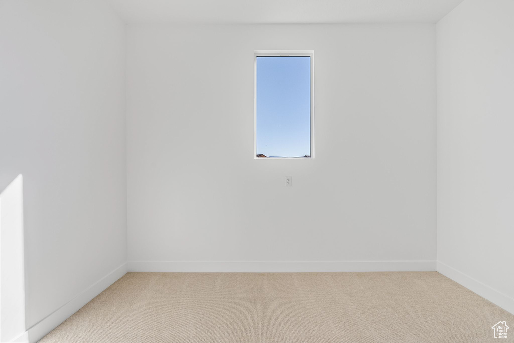 Spare room featuring light carpet