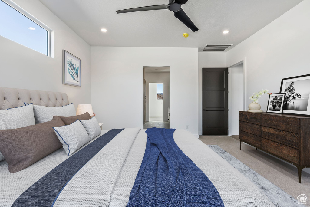 Bedroom with ceiling fan and light colored carpet