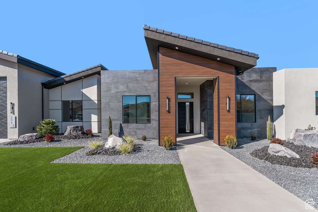View of exterior entry featuring a yard
