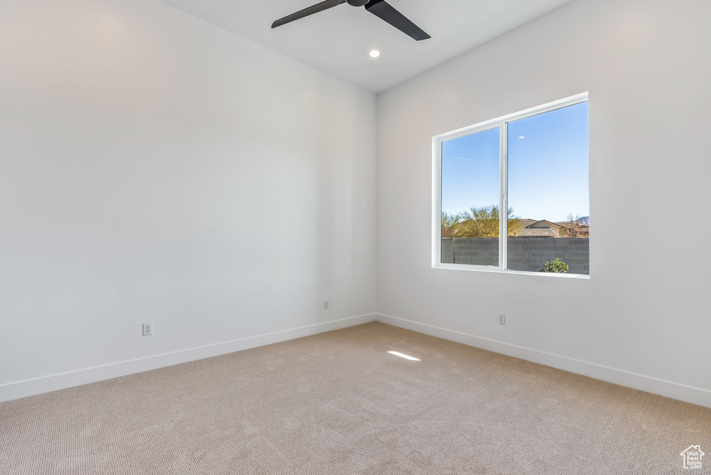 Spare room featuring carpet floors and ceiling fan
