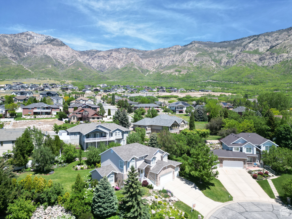 Aerial perspective of suburban area featuring a mountain backdrop