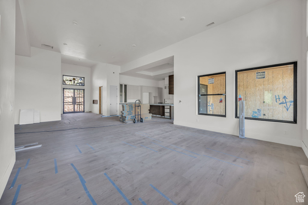 Unfurnished living room with wood finished floors and baseboards
