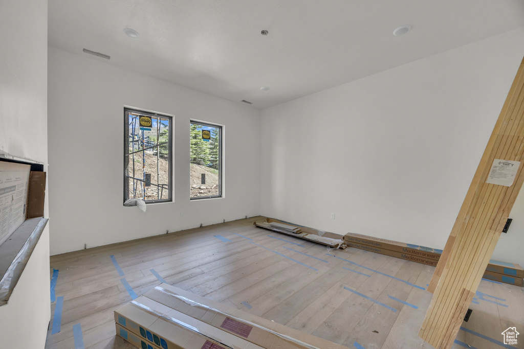 Unfurnished room featuring hardwood / wood-style flooring