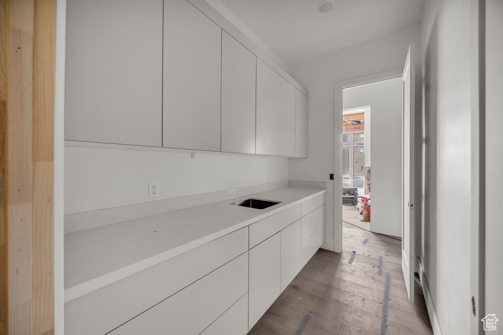 Washroom featuring light wood finished floors