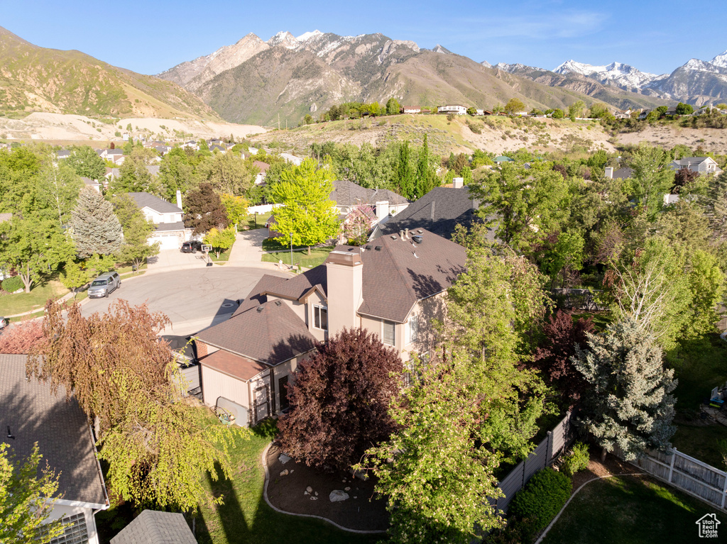 Aerial perspective of suburban area featuring a mountainous background