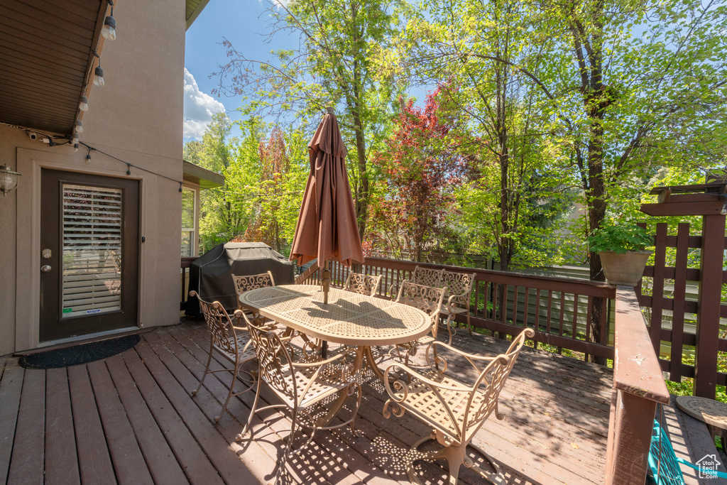 Deck featuring outdoor dining area and grilling area