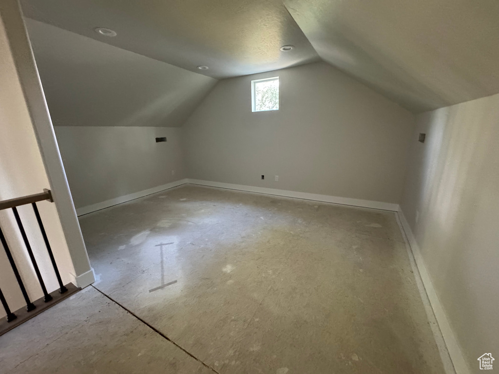 Bonus room with baseboards and lofted ceiling