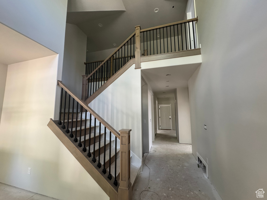 Staircase with a towering ceiling