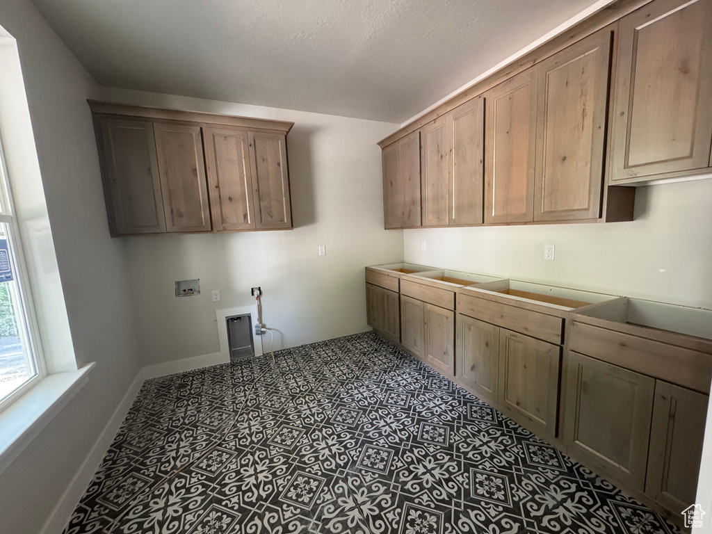 Laundry room with cabinet space and hookup for a washing machine