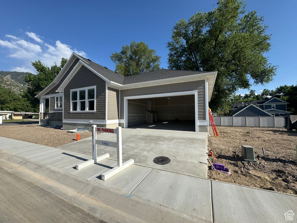 View of front of home with driveway and a garage
