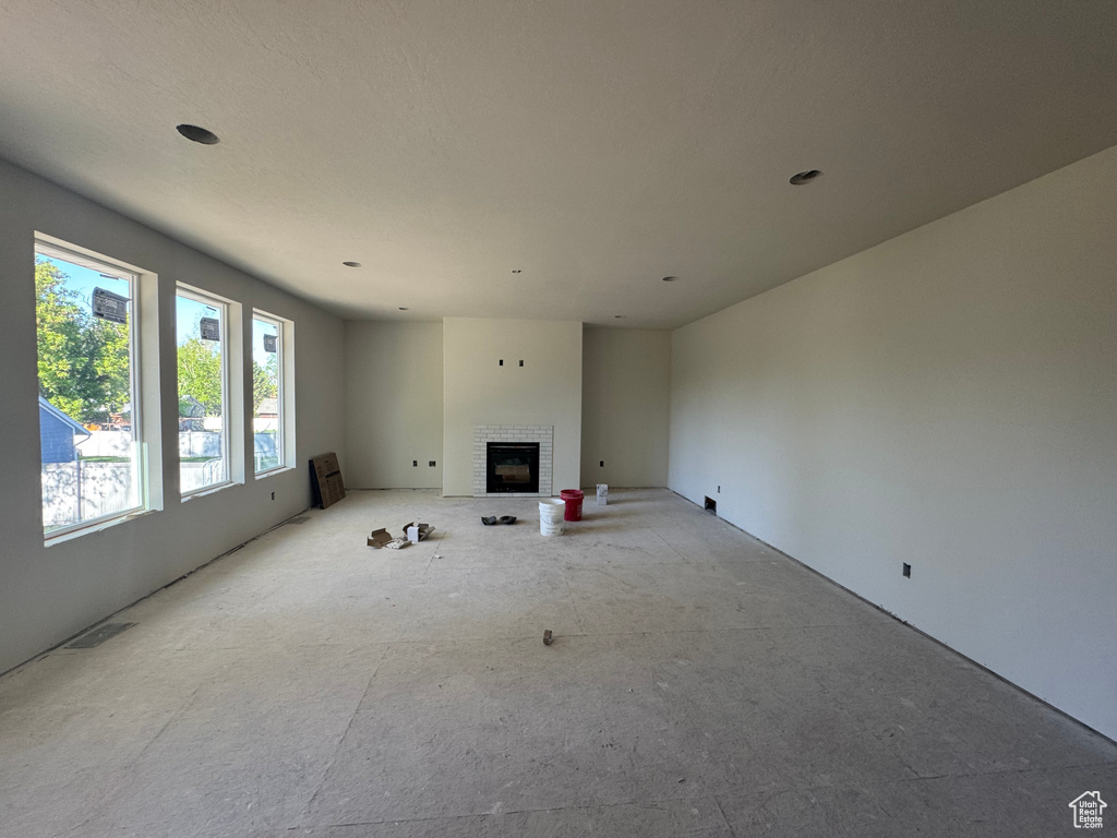 Unfurnished living room featuring a fireplace and visible vents