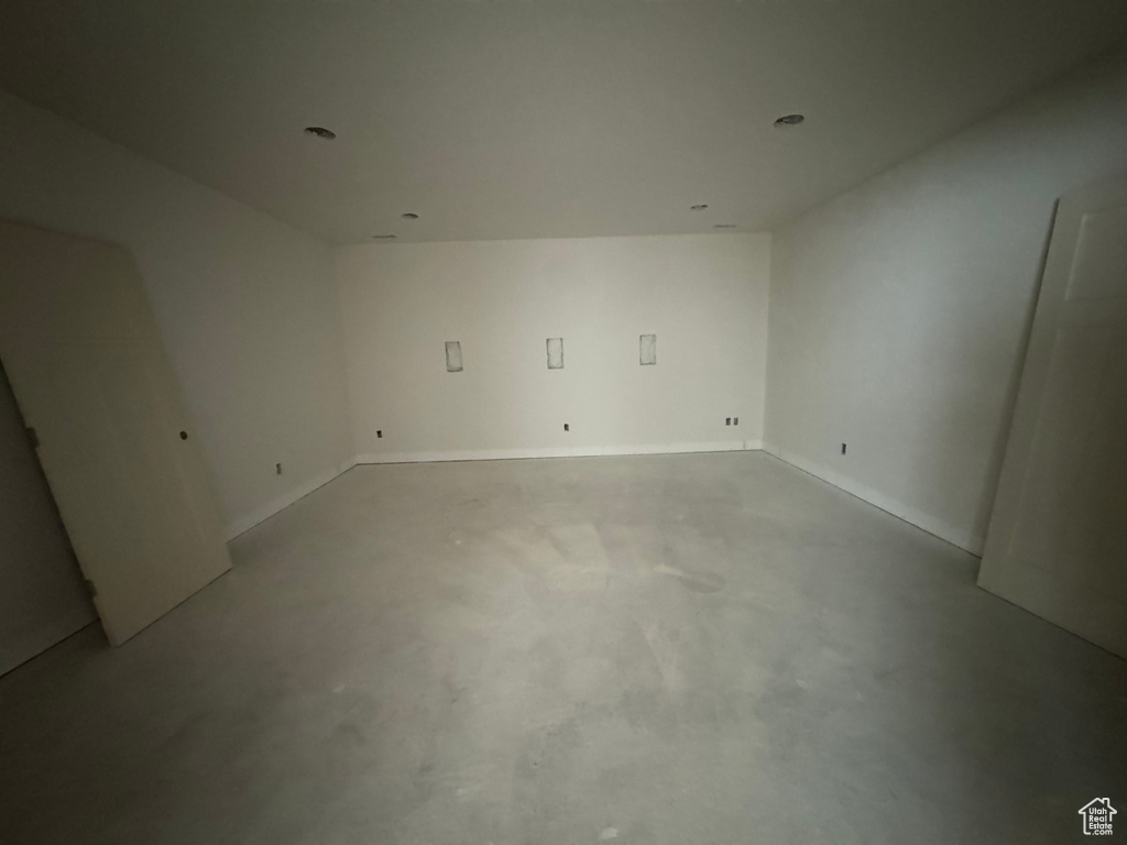Spare room with concrete floors and recessed lighting