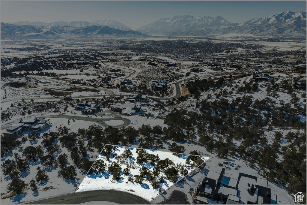 Aerial view of property's location with a mountainous background
