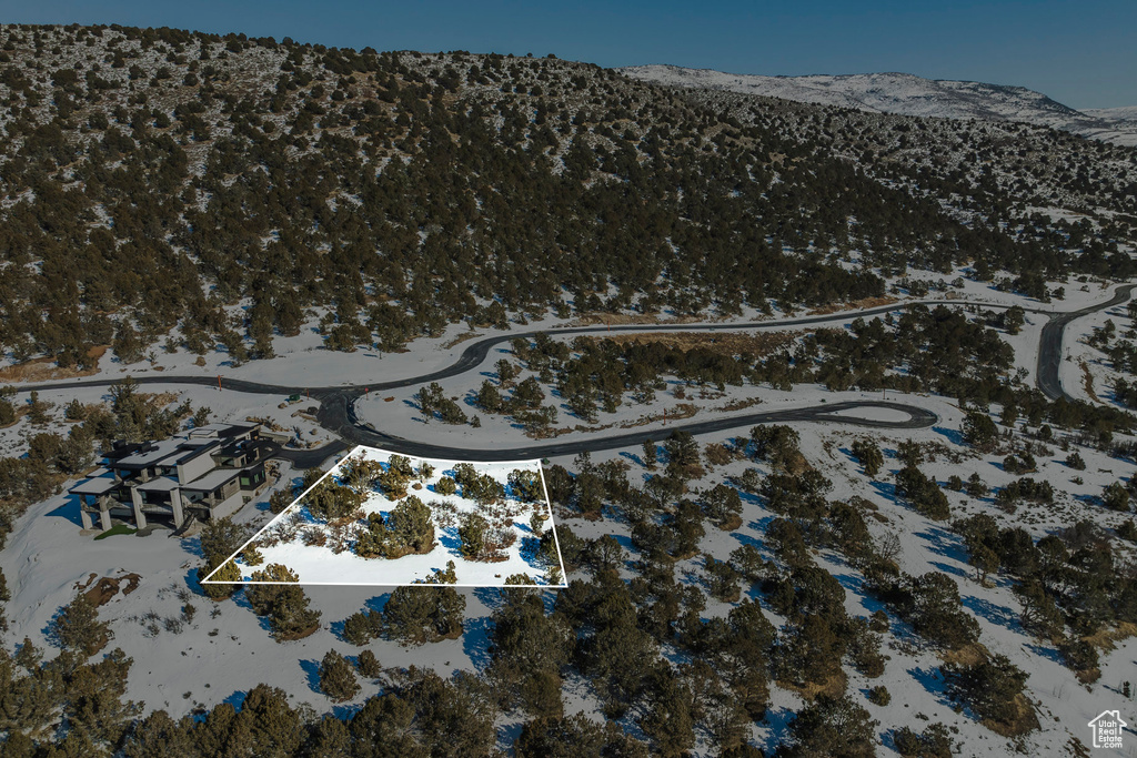 Snowy aerial view featuring a mountain view