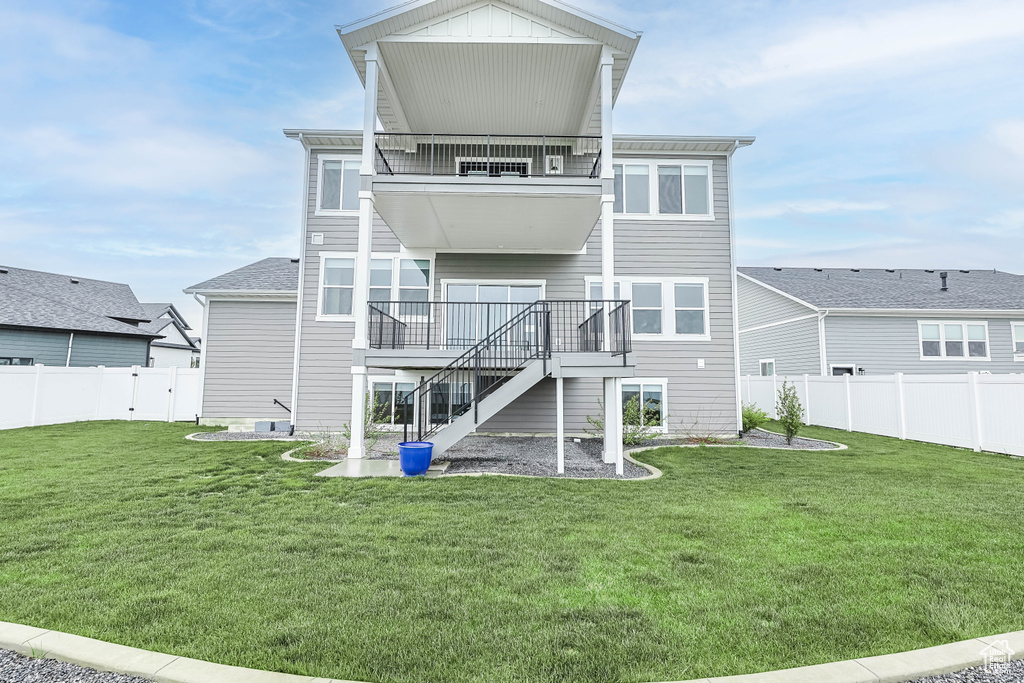 Rear view of property with a balcony and stairs