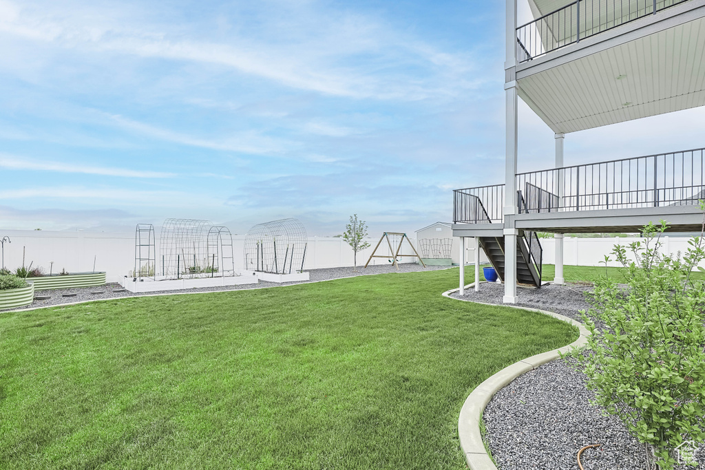 View of green lawn featuring stairway