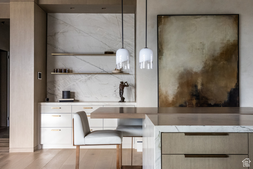 Kitchen with wood finished floors, light countertops, open shelves, and modern cabinets