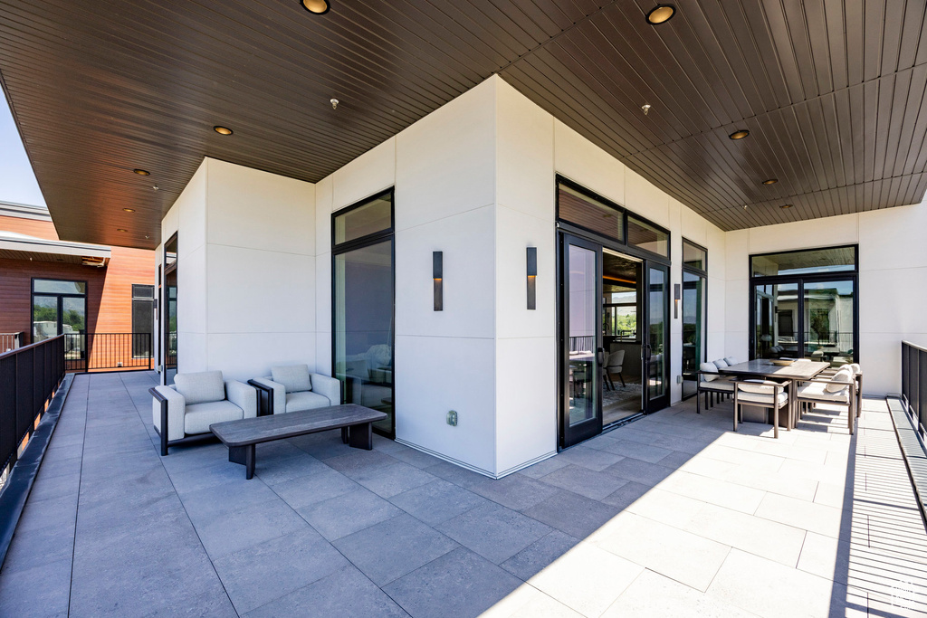 View of patio with an outdoor living space and outdoor dining area