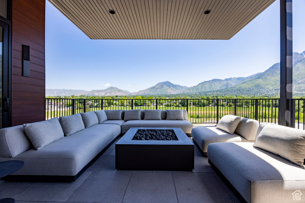 View of patio featuring an outdoor living space with a fire pit and a mountain view