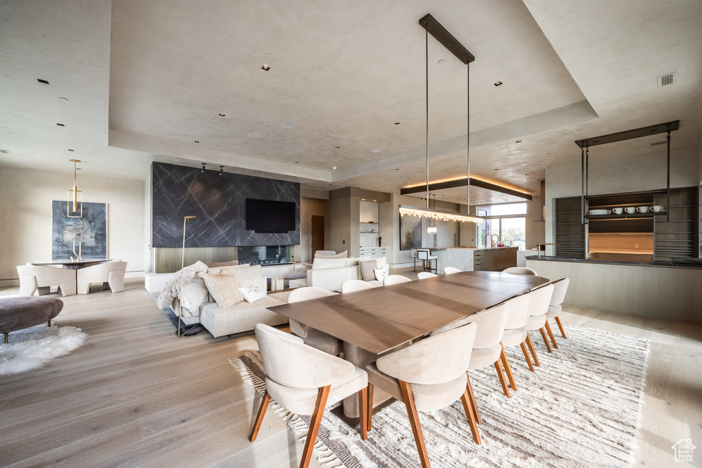 Dining area featuring a tray ceiling and wood finished floors