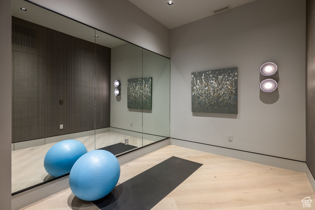 Workout area featuring wood finished floors