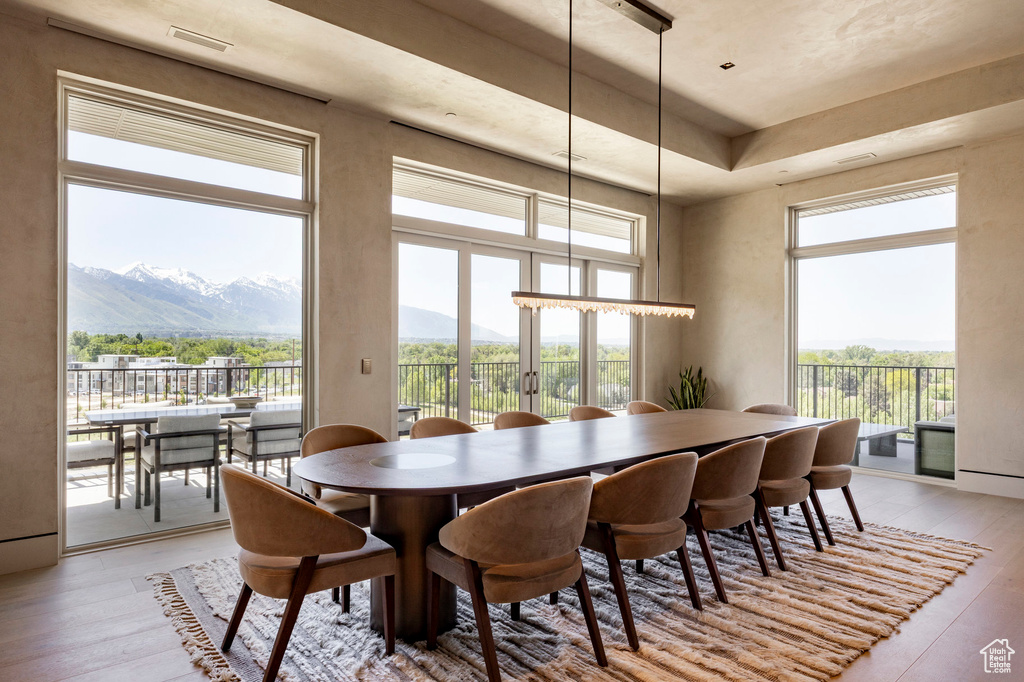 Dining room with a mountain view and light wood-style floors