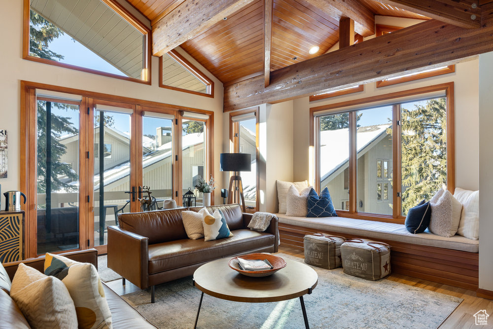 Living room with wood-type flooring, high vaulted ceiling, wood ceiling, and beam ceiling