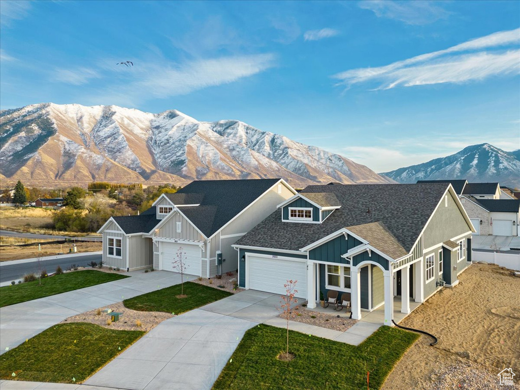 View of front facade with a garage and a mountain view