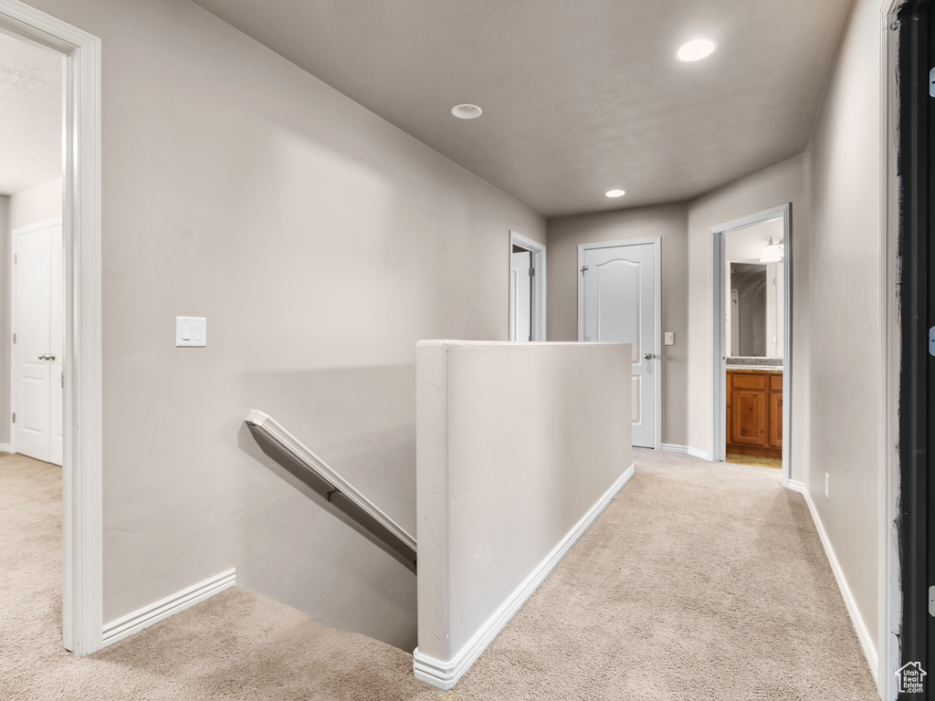 Hallway with light colored carpet