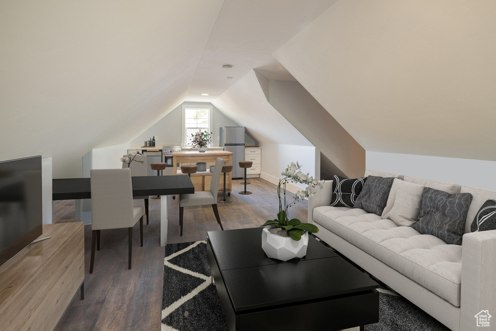 Living area featuring wood finished floors and vaulted ceiling
