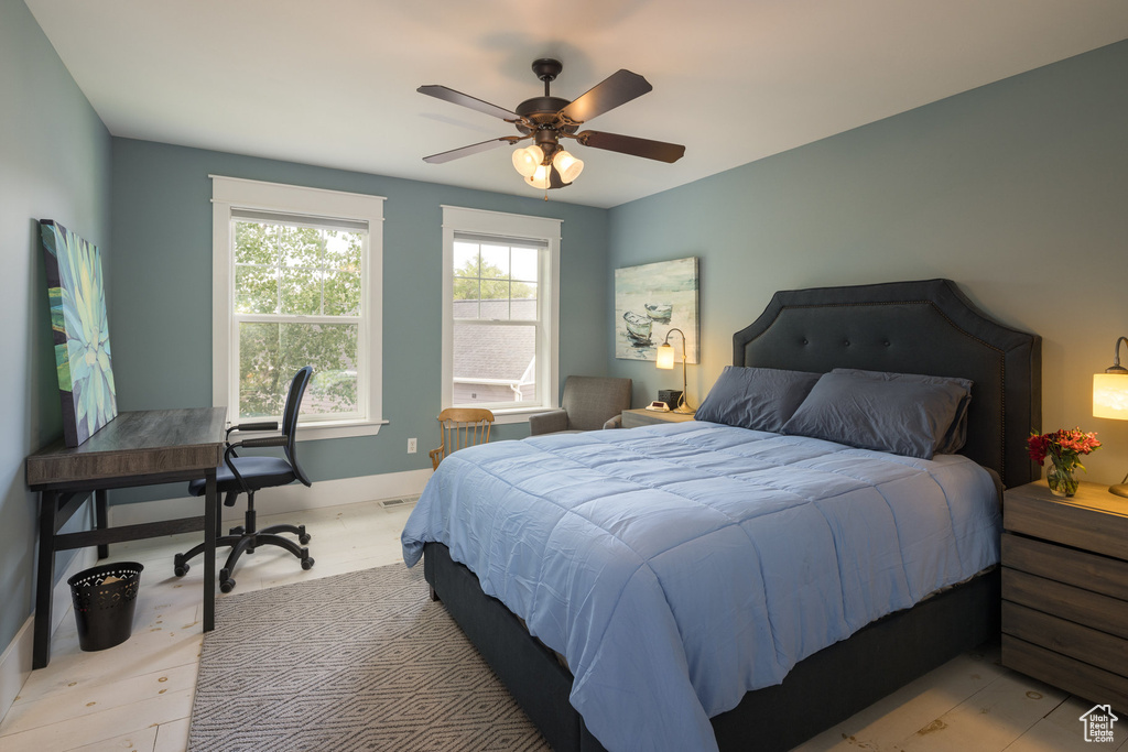 Bedroom with a ceiling fan and baseboards