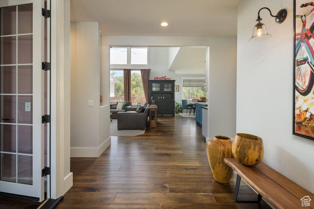 Corridor with dark wood-type flooring, recessed lighting, and baseboards