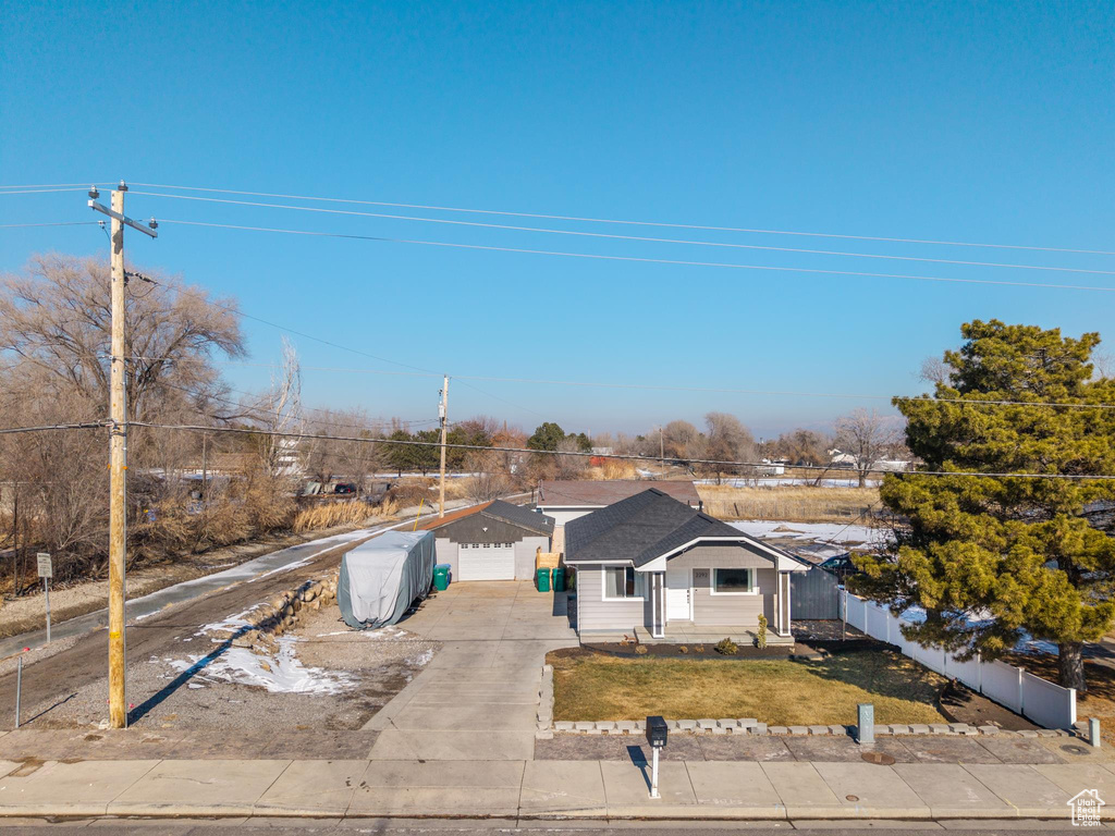 View of front of house featuring a garage and a front yard