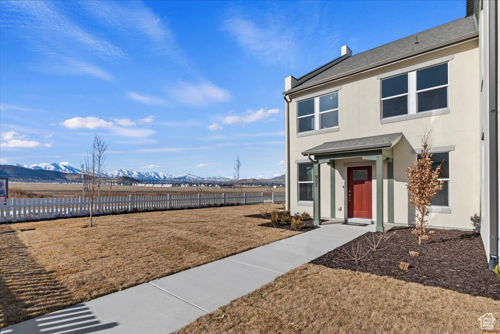 Exterior space with a mountain view and a front lawn