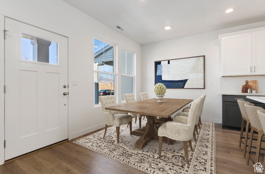 Dining space featuring dark wood-type flooring