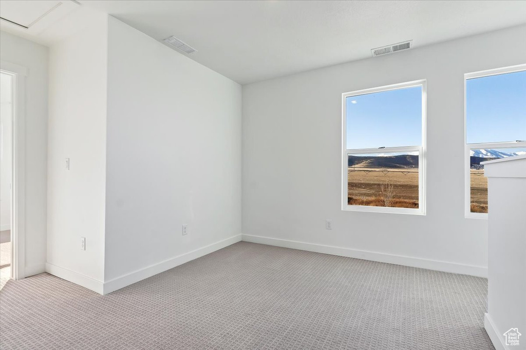 Unfurnished room with light colored carpet